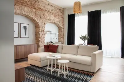 a living room with a couch and a table at Castle Street Modern Apartments I cohost in Vilnius