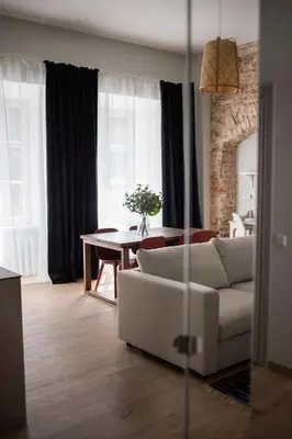 a living room with a couch and a table at Castle Street Modern Apartments I cohost in Vilnius