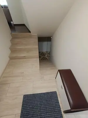 a hallway with a staircase and a rug on the floor at Julia's Apartment