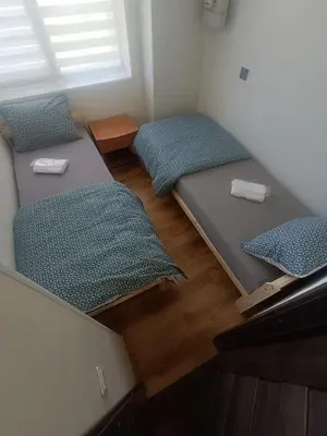 a room with two beds in a room with a window at Julia's Apartment