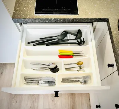 a drawer filled with utensils in a kitchen at M&M Apartment III SELF CHECK-IN in Panevėžys