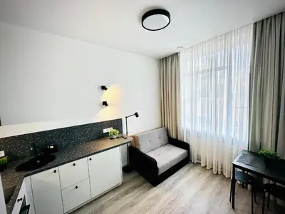a kitchen with a sink and a chair in a room at M&M Apartment III SELF CHECK-IN in Panevėžys