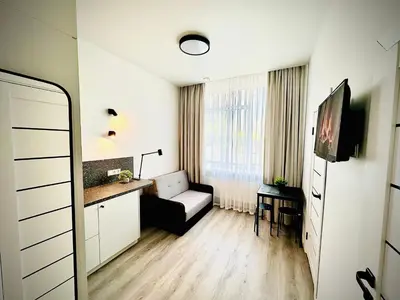 a living room with a couch and a table at M&M Apartment III SELF CHECK-IN in Panevėžys