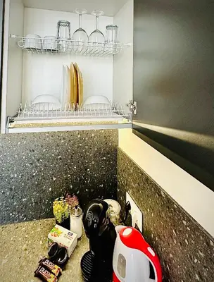 a kitchen with a counter top with a helmet on it at M&M Apartment III SELF CHECK-IN in Panevėžys