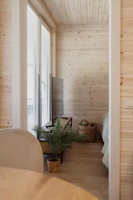 a room with wooden walls and a table and a television at Vakaris in Pabradė