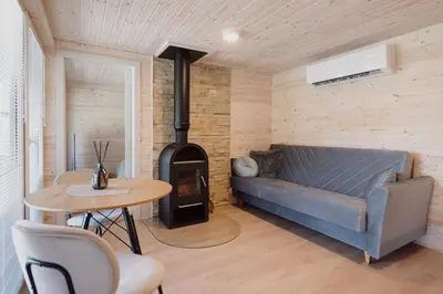 a living room with a couch and a wood stove at Vakaris in Pabradė