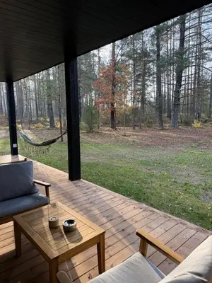 a screened in porch with a couch and a table at Miško Kortai