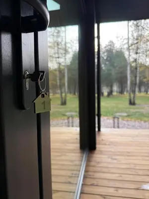 a door with a lock on it with a view of a park at Miško Kortai