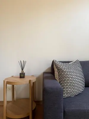 a living room with a blue couch and a table at Miško Kortai