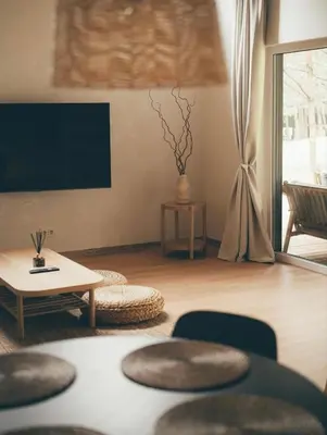 a living room with a table and a tv at Miško Kortai