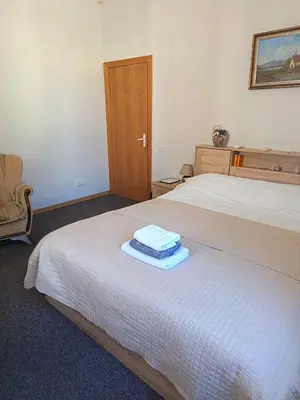 a bedroom with two beds with towels on the bed at Studija Mona in Vilnius