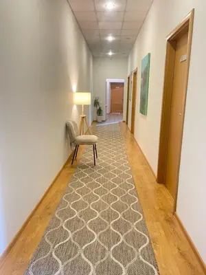 an empty hallway with a chair and a lamp at Studija Mona in Vilnius