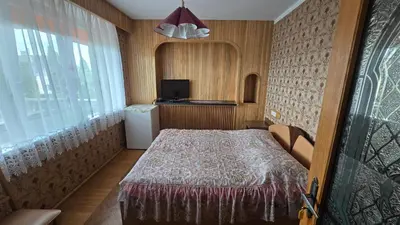 a small room with a bed and a television at Pas Povilą in Jurbarkas