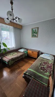 a living room with two beds and a window at Pas Povilą in Jurbarkas