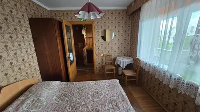 a bedroom with a bed and a window and a table at Pas Povilą in Jurbarkas