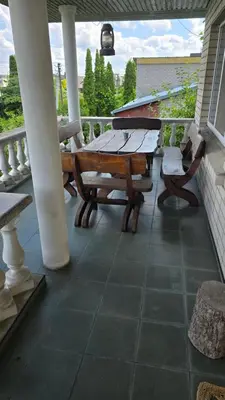 a patio with a table and chairs on a porch at Pas Povilą in Jurbarkas