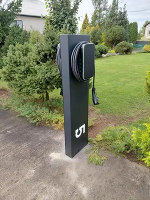 a pay phone in a park with a yard at Spacious & Private Stay in Garliava 120kv in Garliava