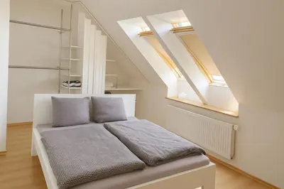 a bed in a room with some skylights at Spacious & Private Stay in Garliava 120kv in Garliava