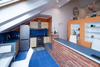 a kitchen with blue tiles and a brick wall at Spacious & Private Stay in Garliava 120kv in Garliava