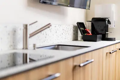 a kitchen counter with a sink and a knife block at Embassy Studio 303 in Vilnius