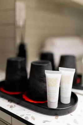 a tray with three hats and three cups on it at Embassy Studio 303 in Vilnius