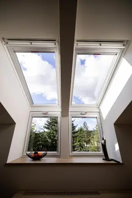 three windows in a room with the sky at Embassy Studio 303 in Vilnius
