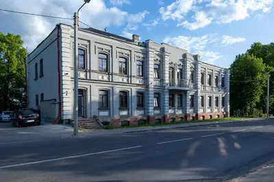 a white building on the side of a street at Tiny Brick Loft in Vilnius