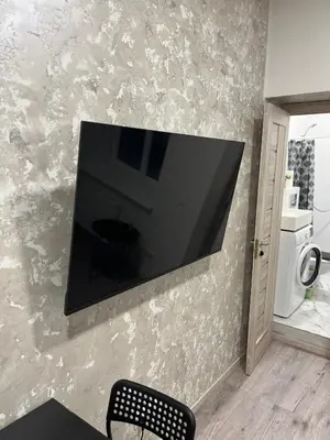 a flat screen tv hanging on a wall at Tiny Brick Loft in Vilnius