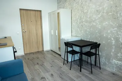 a small black table and two chairs in a room at Tiny Brick Loft in Vilnius
