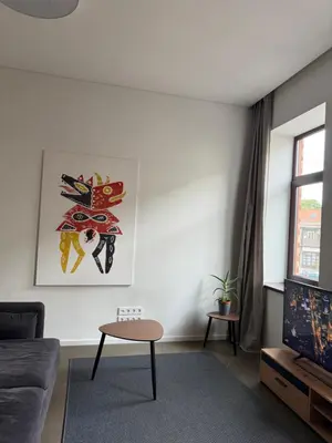 a living room with a couch and a table at Nemunas Apartaments in Kaunas