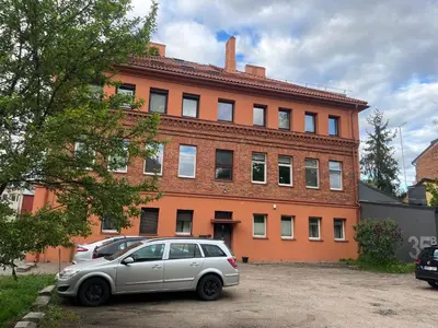 a silver car parked in front of a building at Nemunas Apartaments in Kaunas