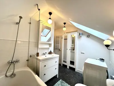 a bathroom with a tub and a sink and a toilet at #stayhere - Light Central 2 BDR Druskininkai apartment in Druskininkai