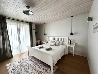 a bedroom with a white bed and a large window at #stayhere - Light Central 2 BDR Druskininkai apartment in Druskininkai