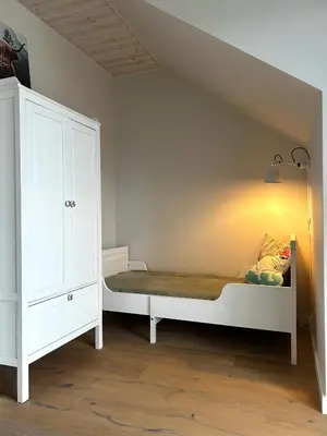 a bedroom with a bed and a white cabinet at #stayhere - Light Central 2 BDR Druskininkai apartment in Druskininkai