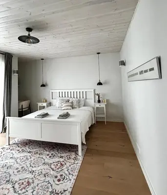 a bedroom with a white bed and a rug at #stayhere - Light Central 2 BDR Druskininkai apartment in Druskininkai
