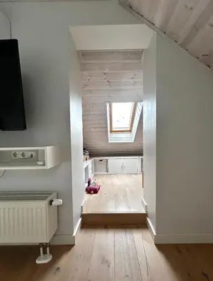 a child sitting on the floor in a room with a window at #stayhere - Light Central 2 BDR Druskininkai apartment in Druskininkai