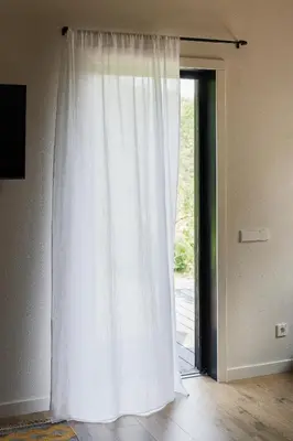 a white curtain in front of a door at Sapnų cechas in Merkinė