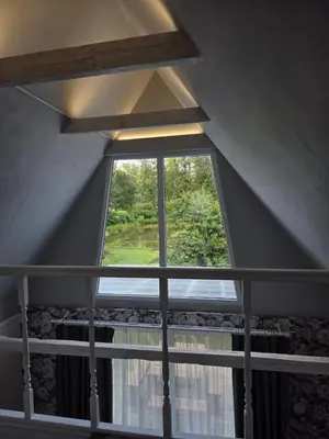 a large window in a room with a balcony at Sodyba Upulupu