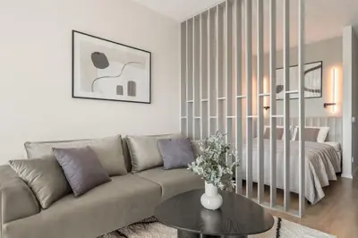 a living room with a couch and a table at Luxury Private Apartment near Old Town and Nature in Vilnius