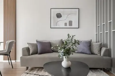 a living room with a couch and a table at Luxury Private Apartment near Old Town and Nature in Vilnius