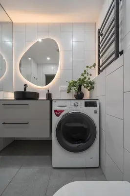a washing machine in a bathroom with a mirror at Luxury Private Apartment near Old Town and Nature in Vilnius