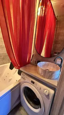 a bathroom with a toilet and a washing machine at Jacuzzi overlooking the tower in Vilnius