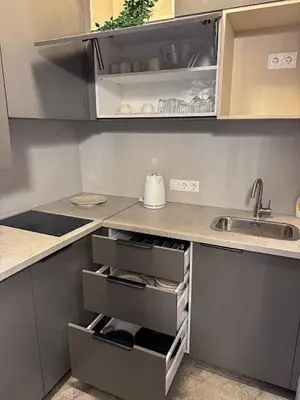 a kitchen with a sink and a counter with open drawers at Jacuzzi overlooking the tower in Vilnius