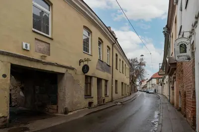 an empty street in an old town with buildings at Jacuzzi overlooking the tower in Vilnius