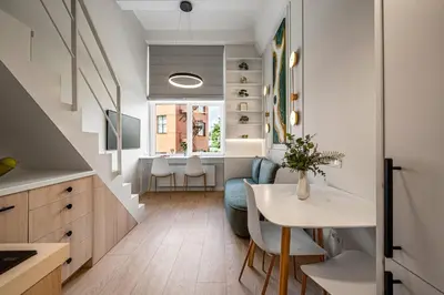 a kitchen with a table and a dining room at Brand New Loft Naujamiestis in Vilnius