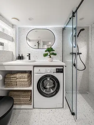 a bathroom with a washing machine and a sink at Brand New Loft Naujamiestis in Vilnius