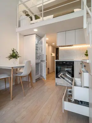 a kitchen and dining room with a table and chairs at Brand New Loft Naujamiestis in Vilnius