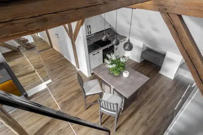 an overhead view of a kitchen and dining room with a table and chairs at ALL SAINTS Residence in Vilnius