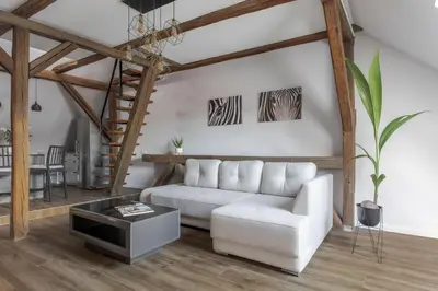 a living room with a white couch and a table at ALL SAINTS Residence in Vilnius