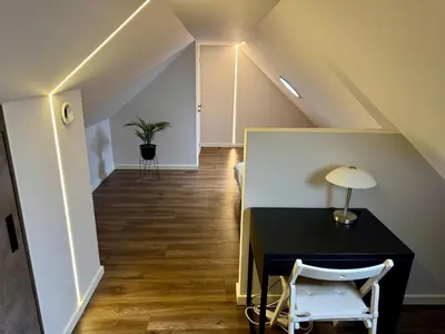 a room with a black table and a chair at ALL SAINTS Residence in Vilnius